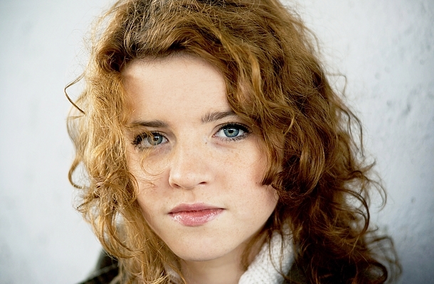 Serious teenager girl with curly hair, portrait
