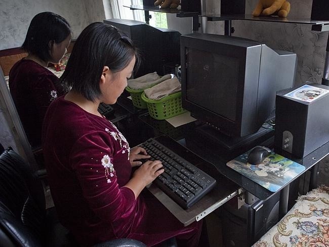a-young-girl-uses-a-computer-but-its-not-turned-on-because-there-is-no-electricity-18